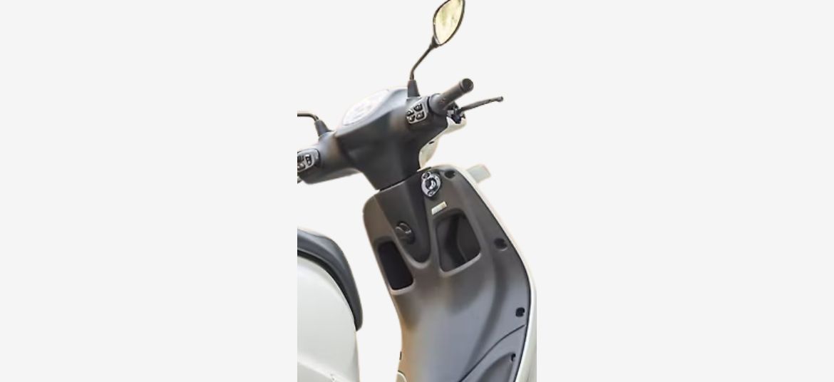 Classic front apron design of Bajaj Chetak C2501 electric scooter with two glove boxes and a bag hook